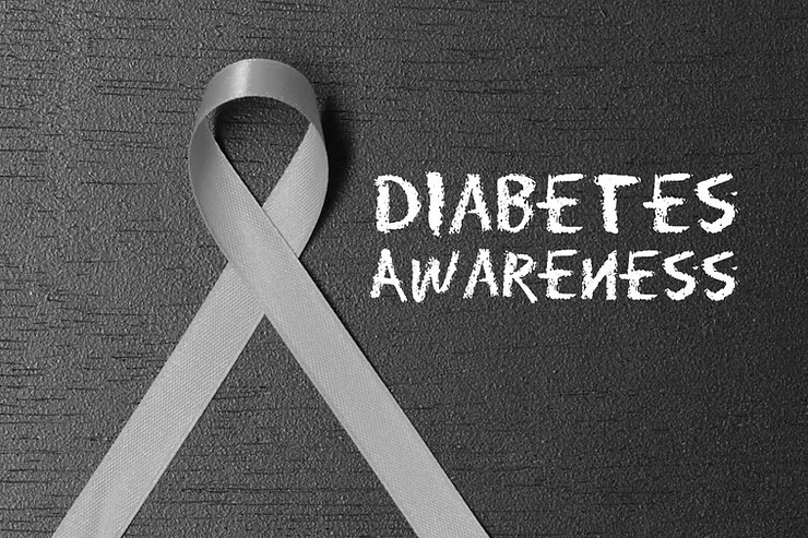 Gray ribbon next to the words “DIABETES AWARENESS” written in chalk.